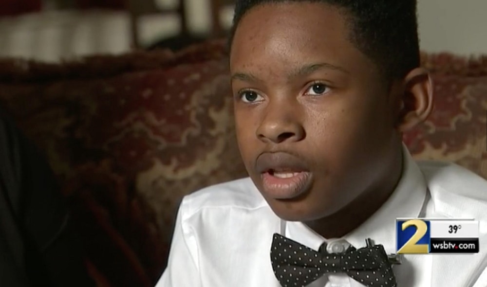 Christian Philon says he was suspended for using money he didn't know what fake to pay for school lunch. (WSB-TV)