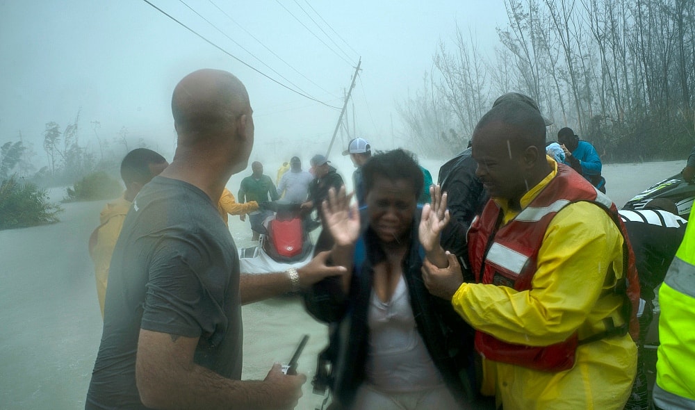 Volunteers rescue several families that arrived on small boats, from the rising waters of Hurricane Dorian, near the Causarina bridge in Freeport, Grand Bahama, Bahamas, Tuesday, Sept. 3, 2019. The storm’s punishing winds and muddy brown floodwaters devastated thousands of homes, crippled hospitals and trapped people in attics. (AP Photo/Ramon Espinosa) thegrio.com