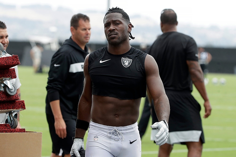 Oakland Raiders' Antonio Brown walks off the field after NFL football practice in Alameda, Calif., Tuesday, Aug. 20, 2019. (AP Photo/Jeff Chiu) thegrio.com