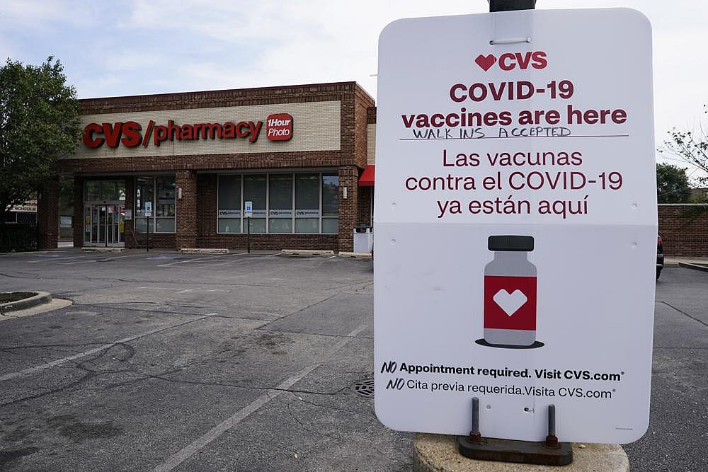 sign regarding COVID-19 vaccine booster is seen outside of a CVS store in Chicago, Ill thegrio.com