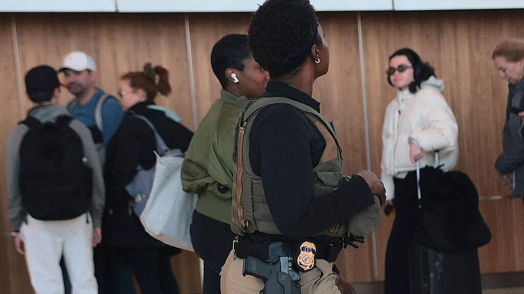 ICE agent, airport, Trump, theGrio.com