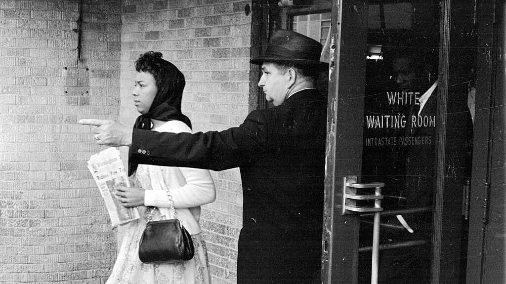 A black woman is directed away from the 'white waiting room, theGrio.com