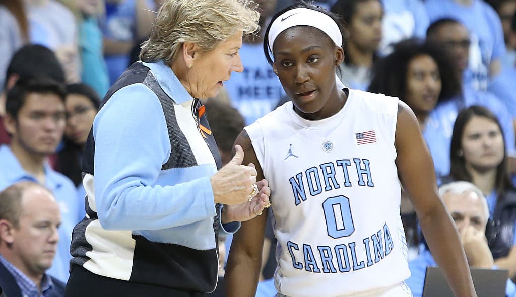 16 November 2014: UNC head coach Sylvia Hatchell (left) talks with Jamie Cherry (0). The University of North Carolina Tar Heels hosted the University of California Los Angeles Bruins at Carmichael Arena in Chapel Hill, North Carolina in a 2014-15 NCAA Division I Women's Basketball game. UNC won the game 84-68. (Photo by Andy Mead/YCJ/Icon Sportswire/Corbis via Getty Images) thegrio.com