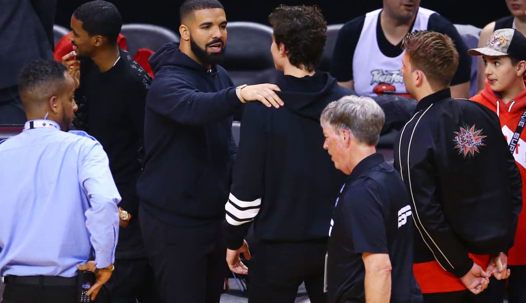 Drake and Shawn Mendes meet during Game Two of the 2019 NBA Finals between the Golden State Warriors and the Toronto Raptors at Scotiabank Arena on June 02, 2019 in Toronto, Canada. NOTE TO USER: User expressly acknowledges and agrees that, by downloading and or using this photograph, User is consenting to the terms and conditions of the Getty Images License Agreement. (Photo by Vaughn Ridley/Getty Images)