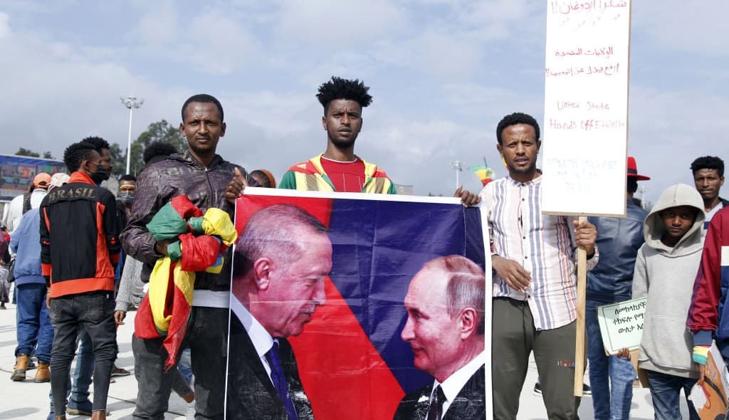 Ethiopians hold up the poster of Turkish President Recep Tayyip Erdogan and Vladimir Putin President of Russia