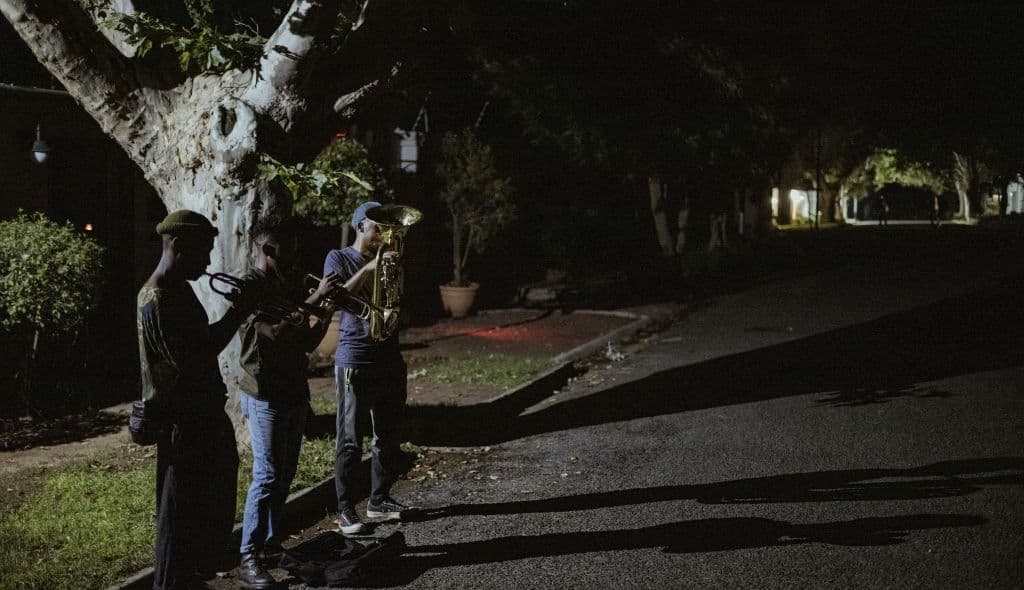 Members of The Middle of the Road Band Smiso, Franqo and Pro, play Christmas carols in Johannesburg