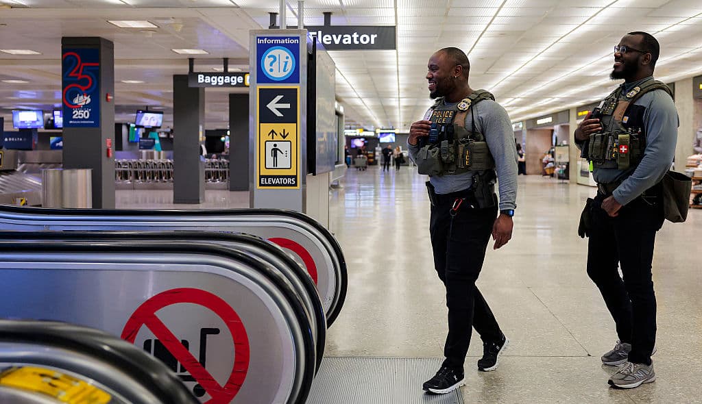 ICE agent, airport, Trump, theGrio.com