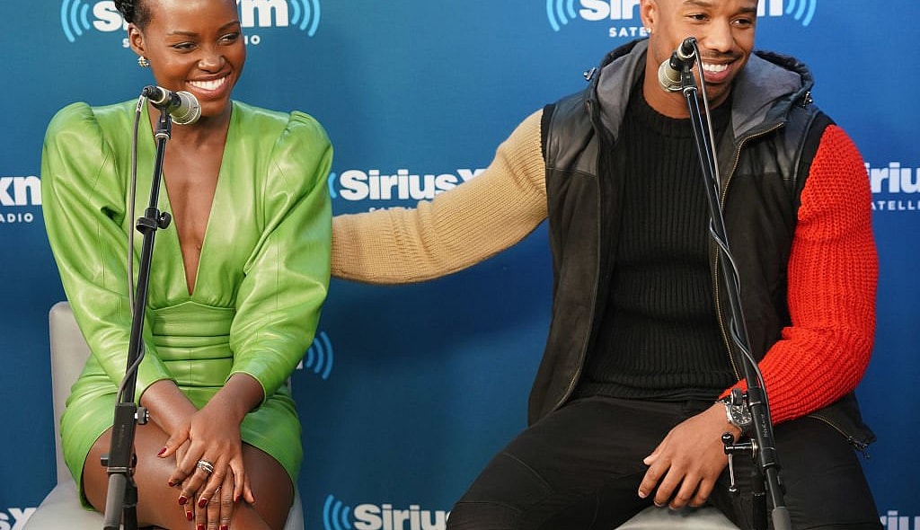 NEW YORK, NY - FEBRUARY 13: Lupita Nyong'o and Michael B. Jordan take part in SiriusXM's Town Hall with the cast of Black Panther hosted by SiriusXM's Sway Calloway on February 13, 2018 in New York City. (Photo by Cindy Ord/Getty Images for SiriusXM) thegrio.com