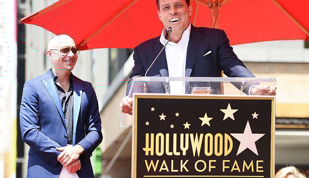 Pitbull (L) and Tony Robbins speak onstage as Pitbull is honored with a Star on The Hollywood Walk of Fame on July 15, 2016 in Hollywood, California. (Photo by Matt Winkelmeyer/Getty Images)