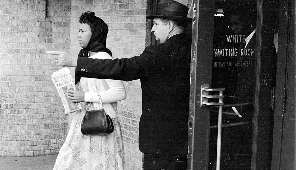 A black woman is directed away from the 'white waiting room, theGrio.com