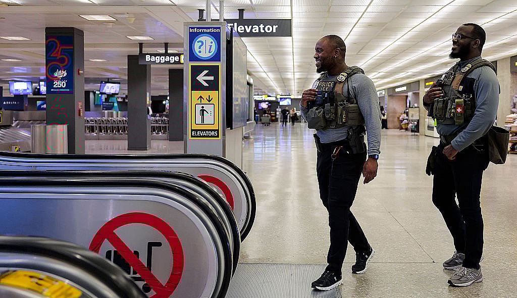 ICE agent, airport, Trump, theGrio.com