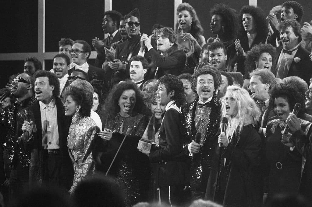A variety of music and movie stars sing “We Are the World”