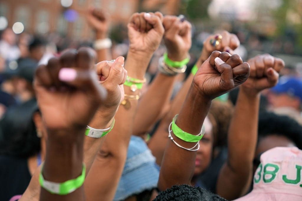 Black women, fists, theGrio.com