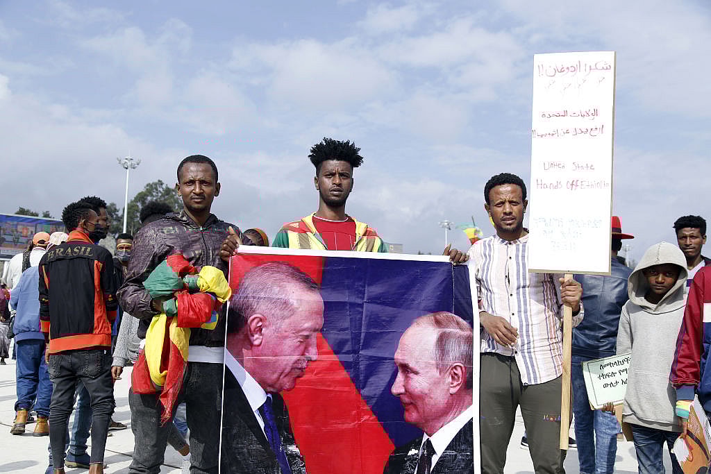 Ethiopians hold up the poster of Turkish President Recep Tayyip Erdogan and Vladimir Putin President of Russia