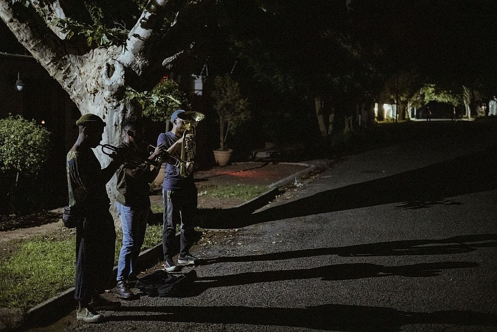 Members of The Middle of the Road Band Smiso, Franqo and Pro, play Christmas carols in Johannesburg