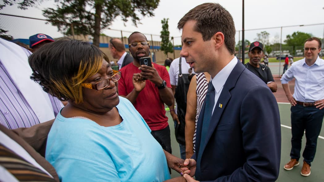In this Wednesday, June 19, 2019 photo, South Bend Mayor and Democratic presidential candidate Pete Buttigieg shares a moment with Shirley Newbill, mother of Eric Logan, during a gun violence memorial at the Martin Luther King Jr. Recreation Center in South Bend, Ind. (Michael Caterina/South Bend Tribune via AP)
