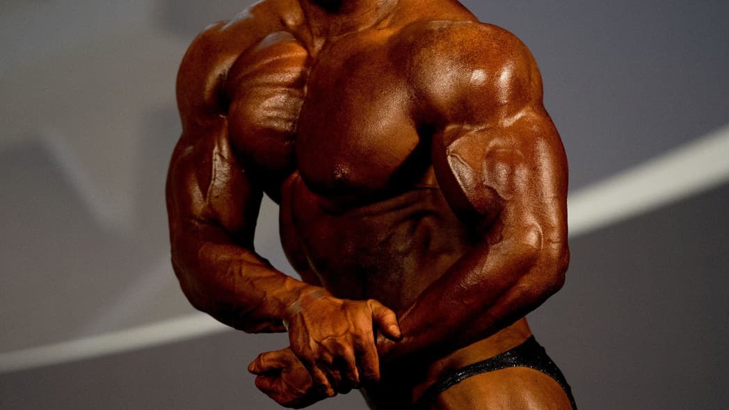 An athlete poses for the judges during the bodybuilding competition
