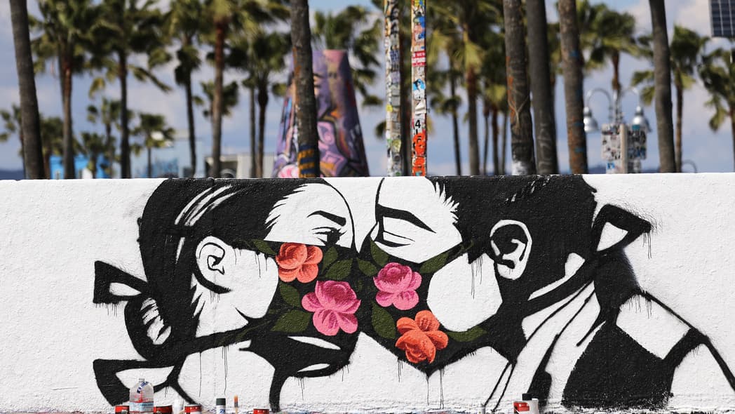 mural kissing coronavirus theGrio.com