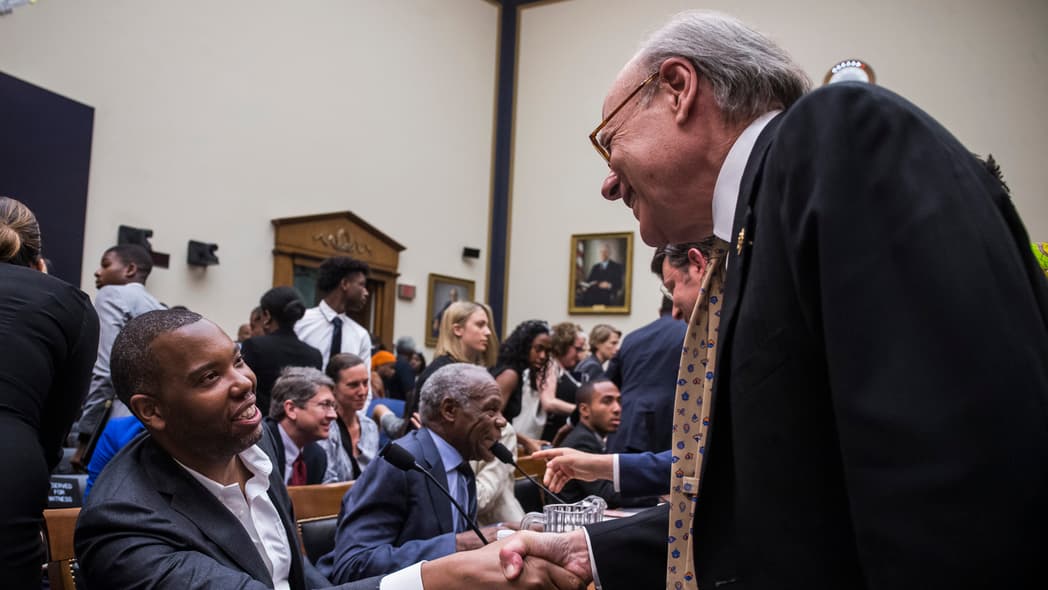 Two men shake hands