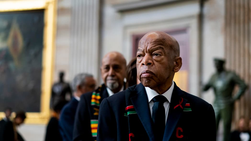 Rep. John Lewis stands solemnly, preparing to pay his respects to Rep. Elijah Cummings during a memorial ceremony in the Capitol's Statuary Hall in 2019.