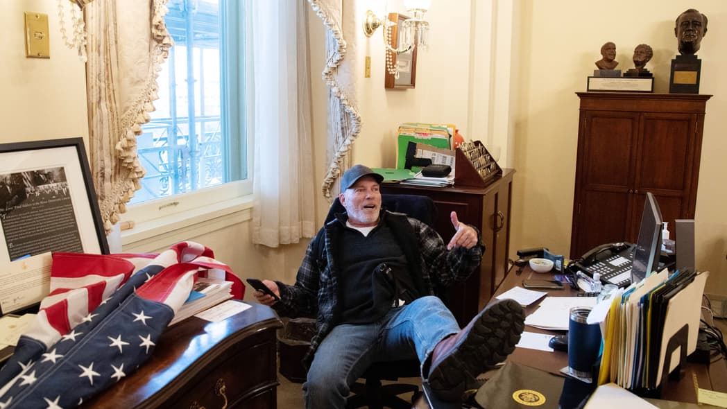 Richard Barnett with his foot on Speaker Nancy Pelosi's desk