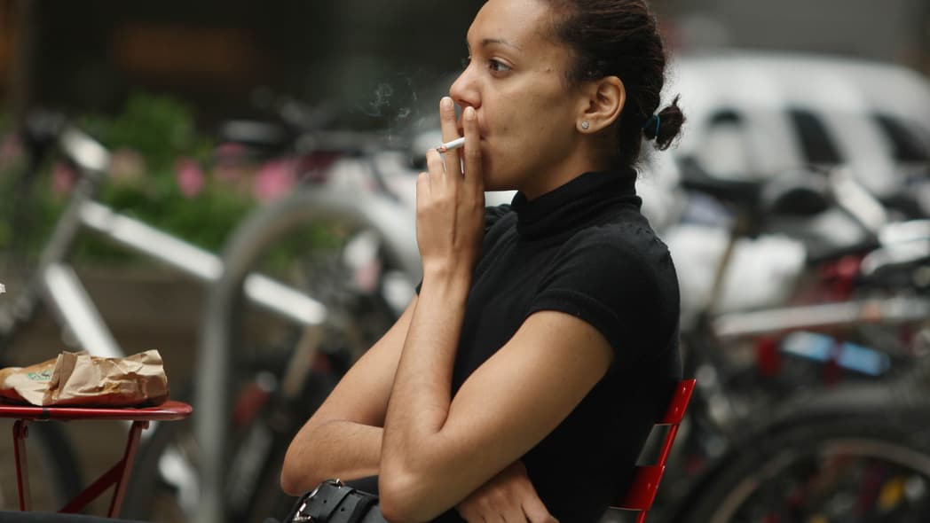 A woman smokes a cigarette