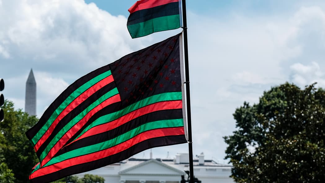 A Pan-African flag flies from Black Lives Matter Plaza overlooking the White House