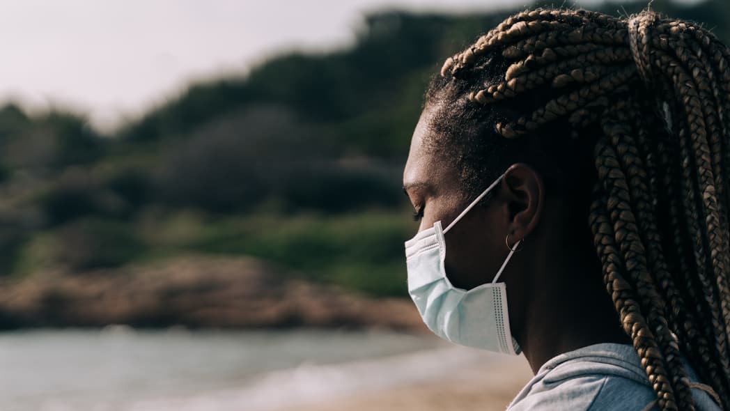 Woman in mask at beach