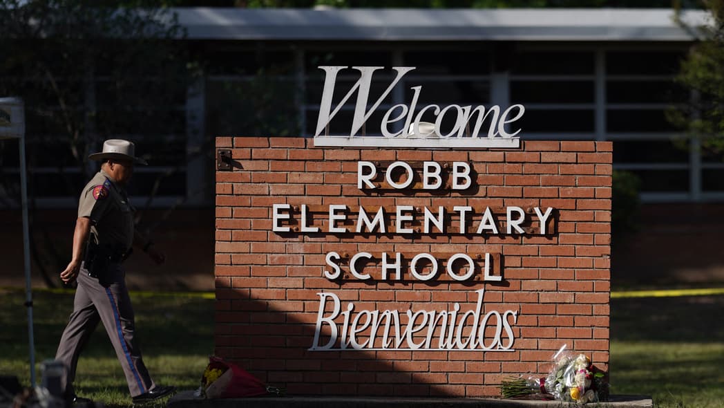An officer walks outside of Robb Elementary School in Uvalde, Texas