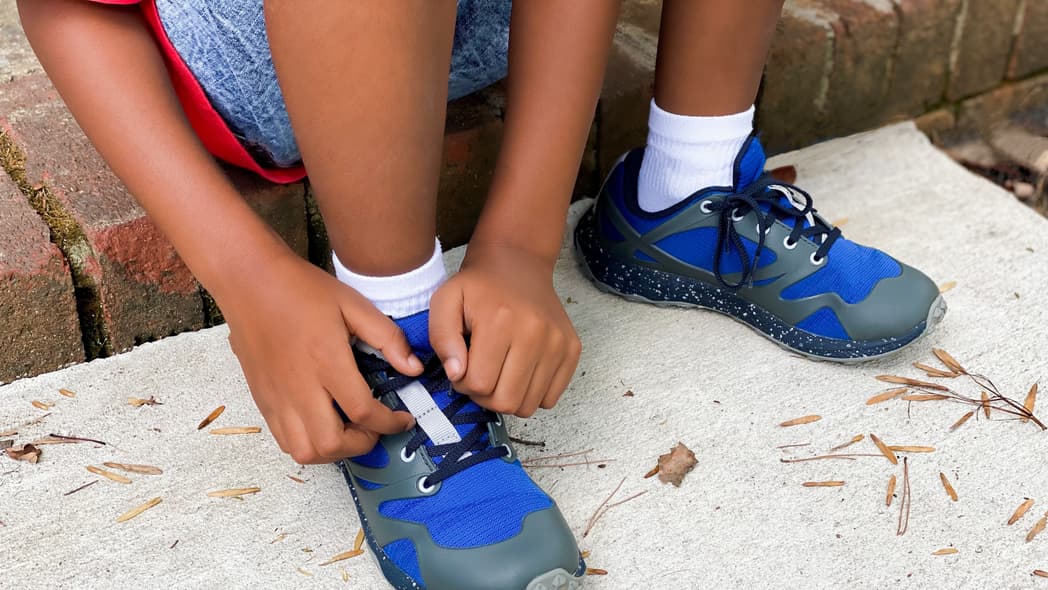 A person tying their shoes