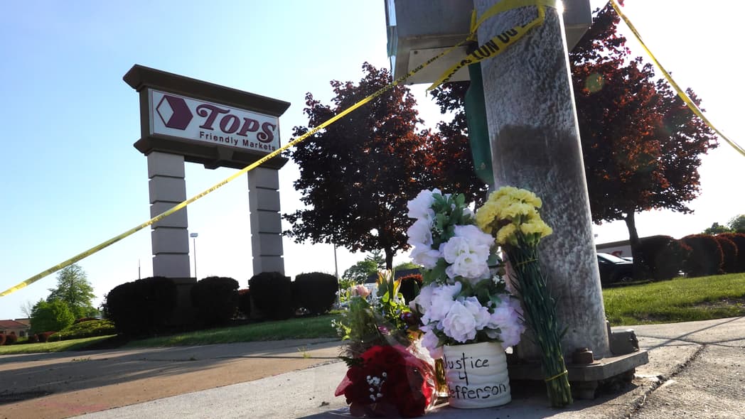 Flowers at a makeshift memorial outside Tops market