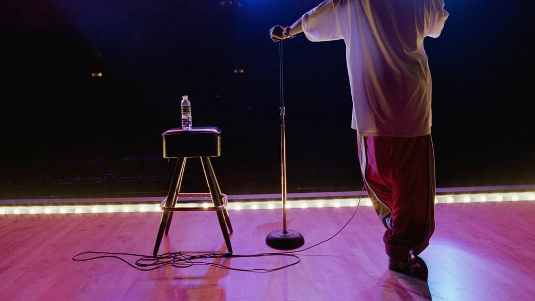 A man on stage facing the audience