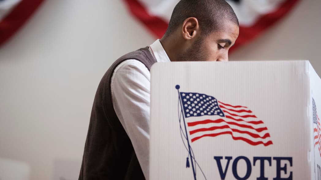 A man inside a voting booth