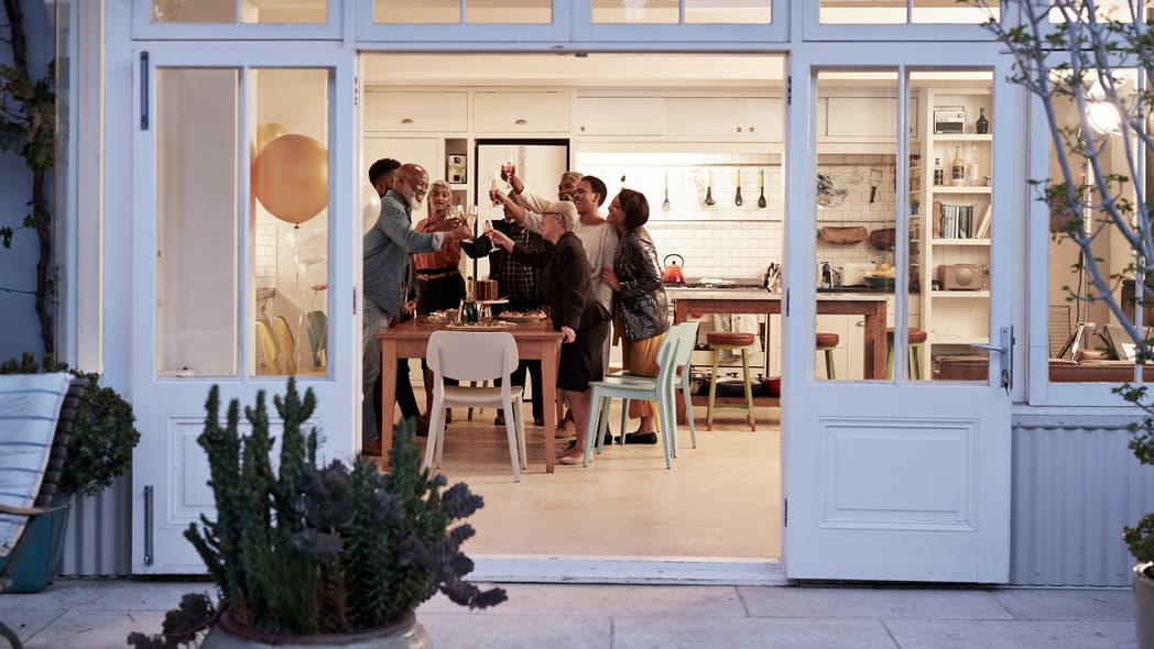 A family toasting around a kitchen table