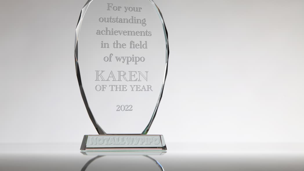 A clear acrylic award reading "For your outstanding achievements in the field of wypipo, Karen of the Year 2022"