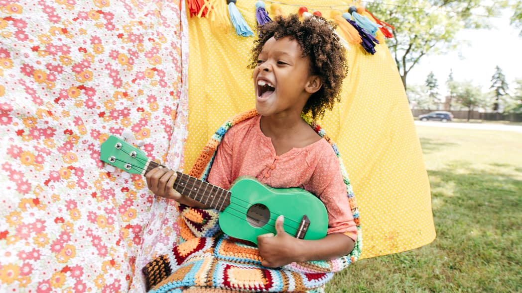 A child playing a toy guitar