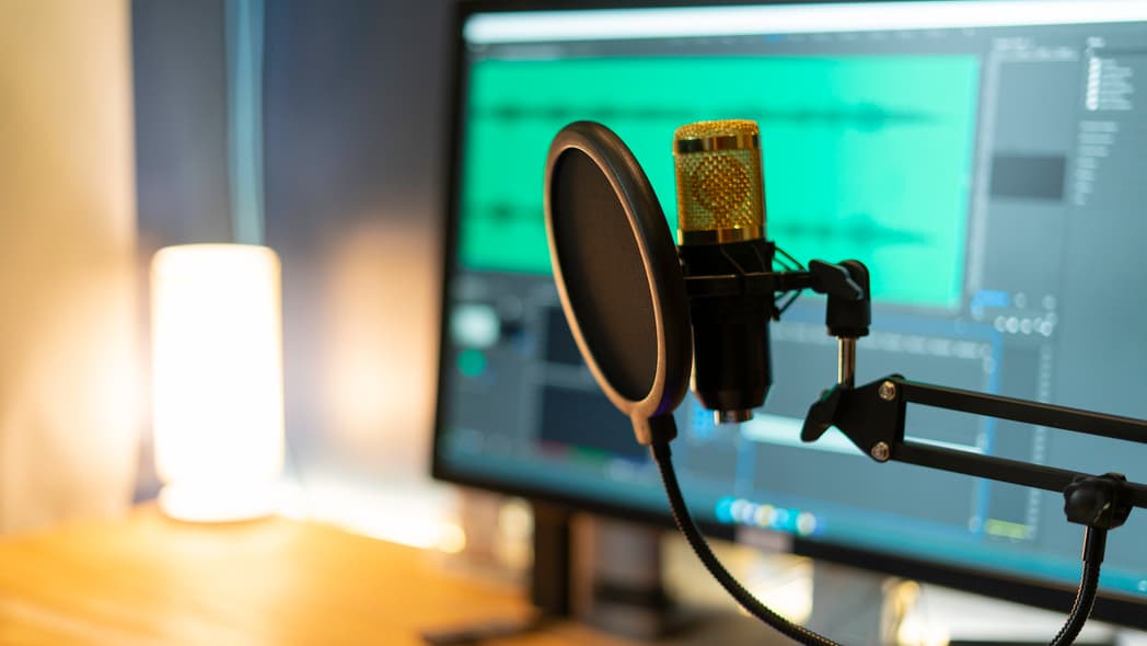 A microphone in front of a computer screen
