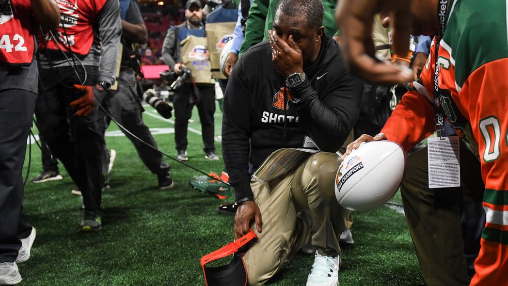 Florida A&M Head Coach Willie Simmons kneels on the ground