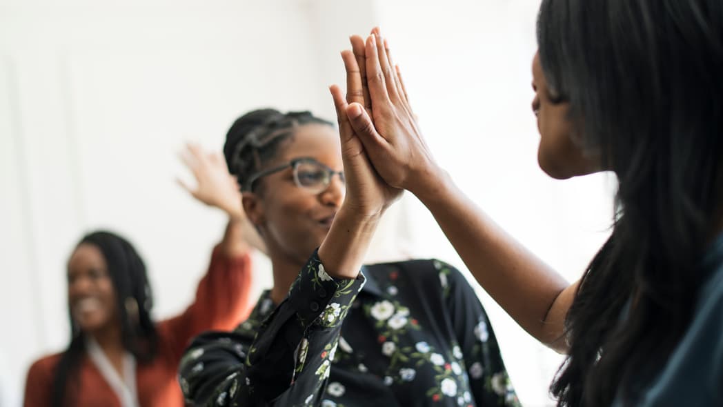 Young women high-fiving each other