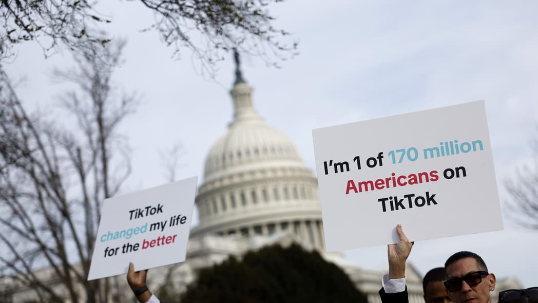 Participants hold signs in support of TikTok outside the U.S. Capitol Building