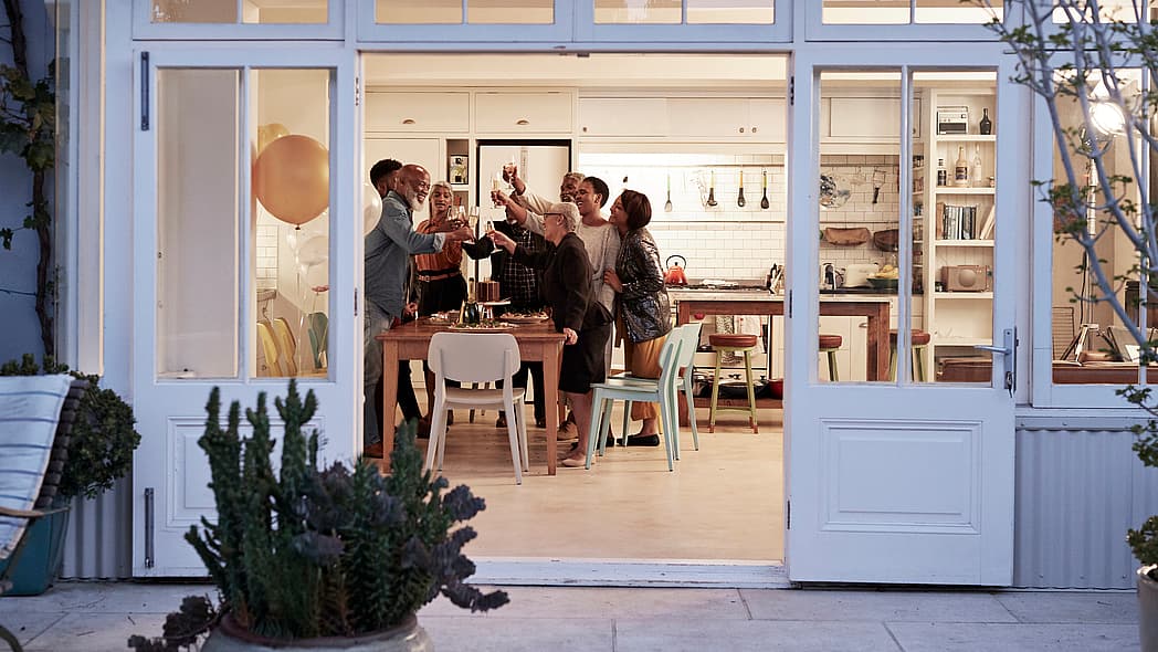 A family toasting around a kitchen table
