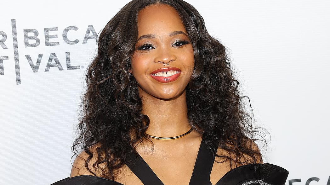 Actor Quvenzhané Wallis, wearing a black dress and gold necklace