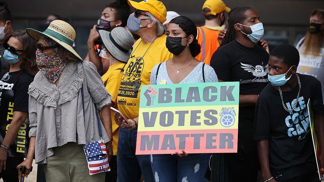 A group of protesters with a "Black Votes Matter" sign