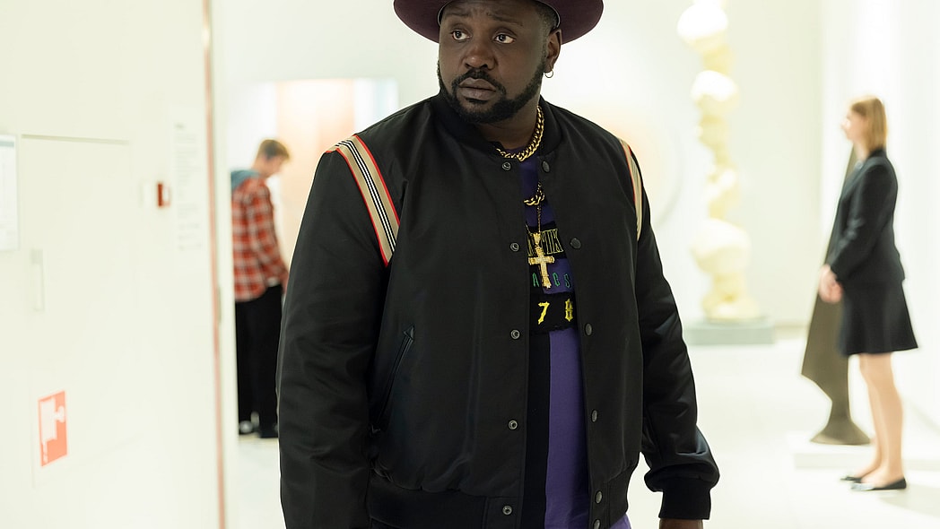 Actor Brian Tyree Henry in a black jacket and hat portrays Alfred "Paper Boi" Miles in "Atlanta"
