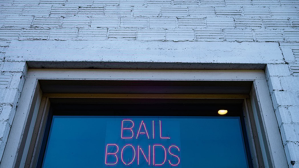 A neon sign reading "Bail Bonds"