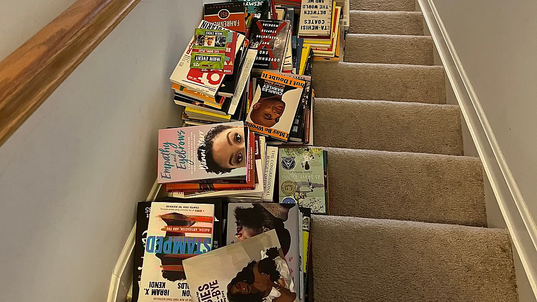 A staircase with stacks of books