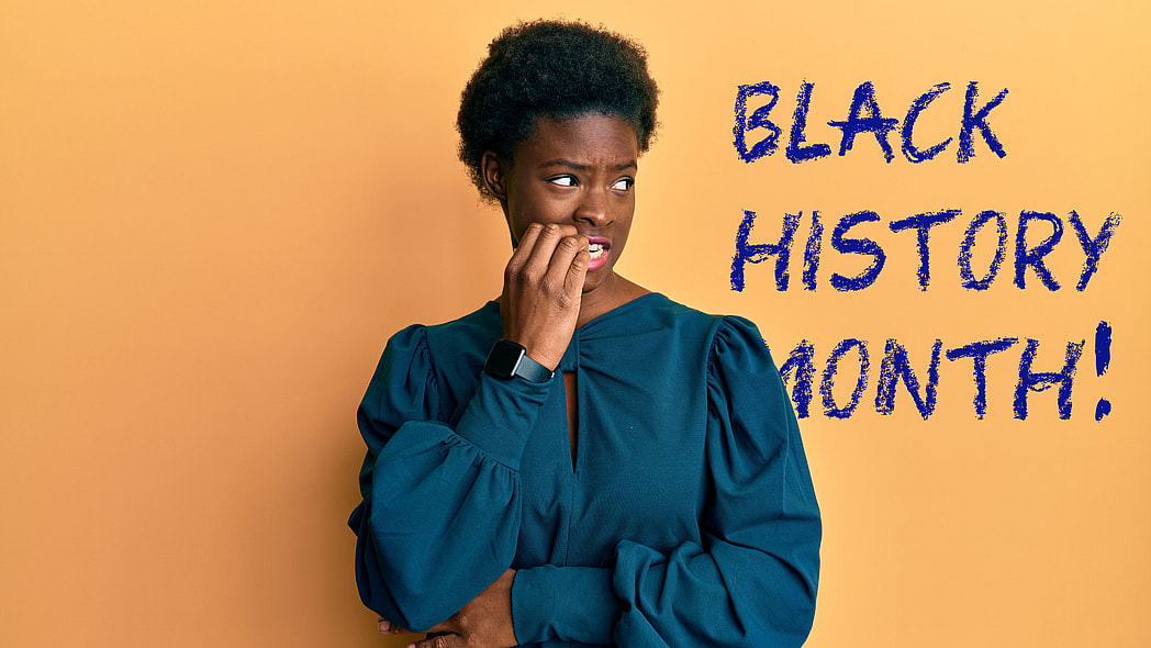 A worried person stands before a wall reading "Black History Month!"
