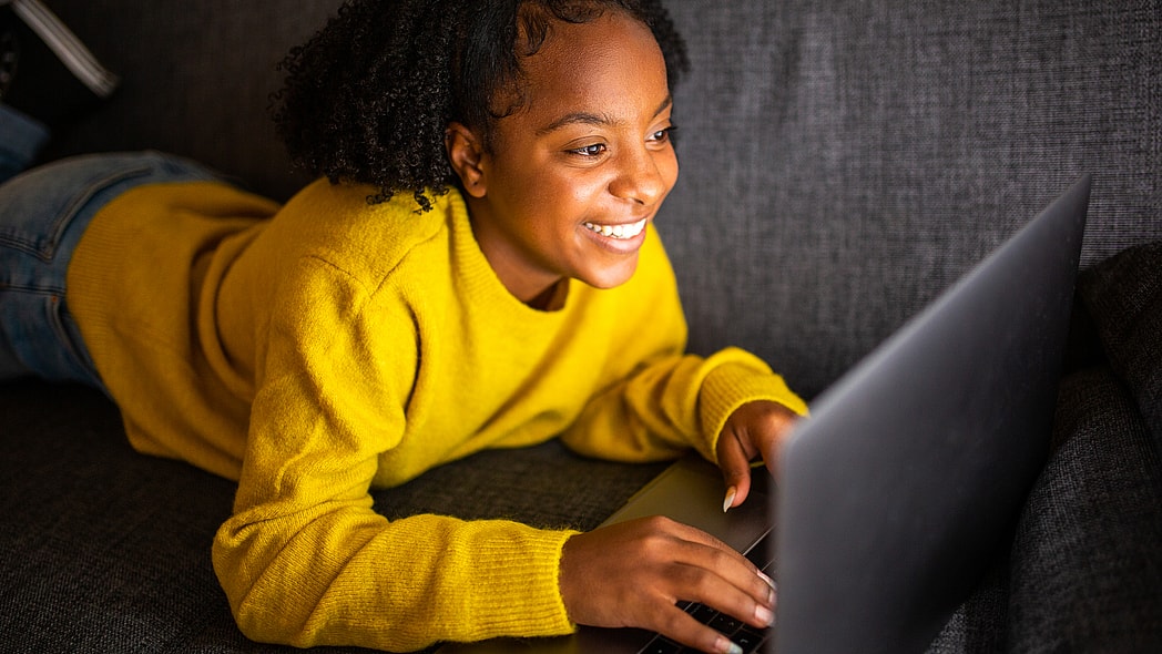 A girl works on a laptop