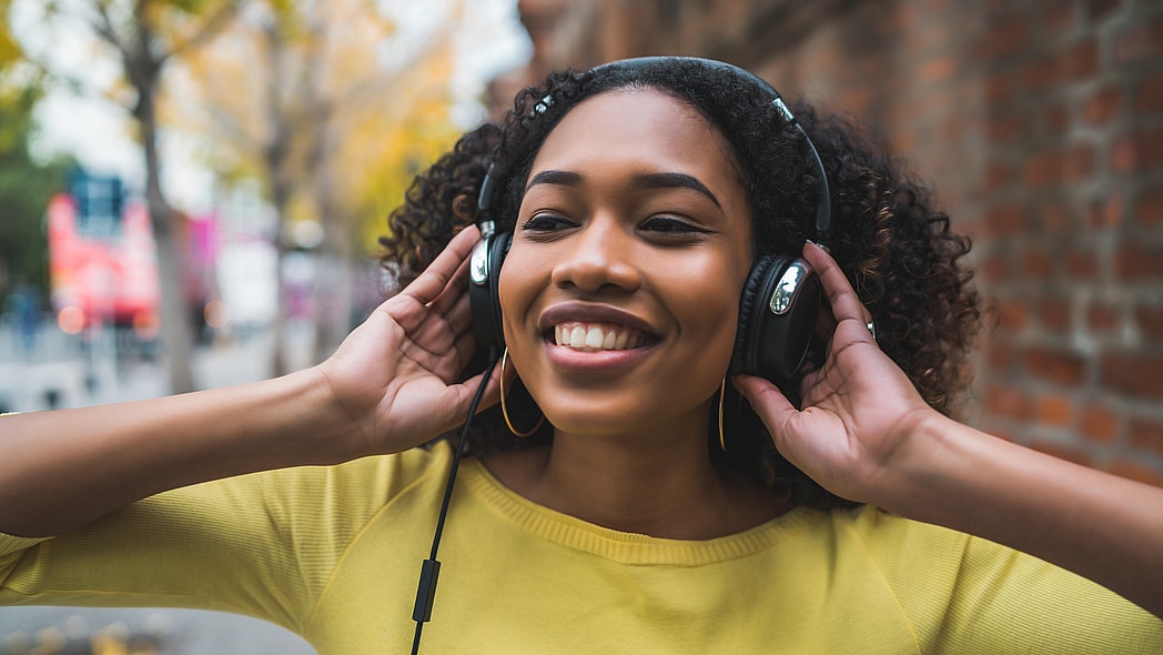 A young woman listens to headphones