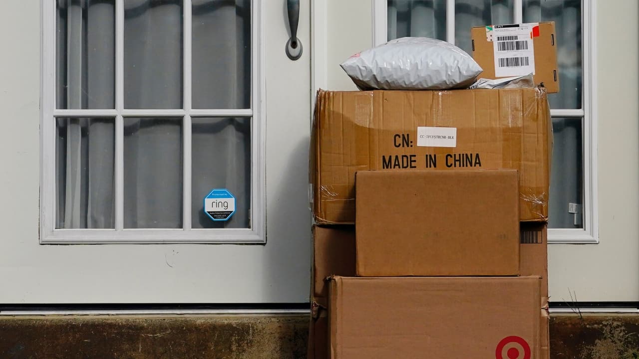 Packages stacked on the doorstep of a home